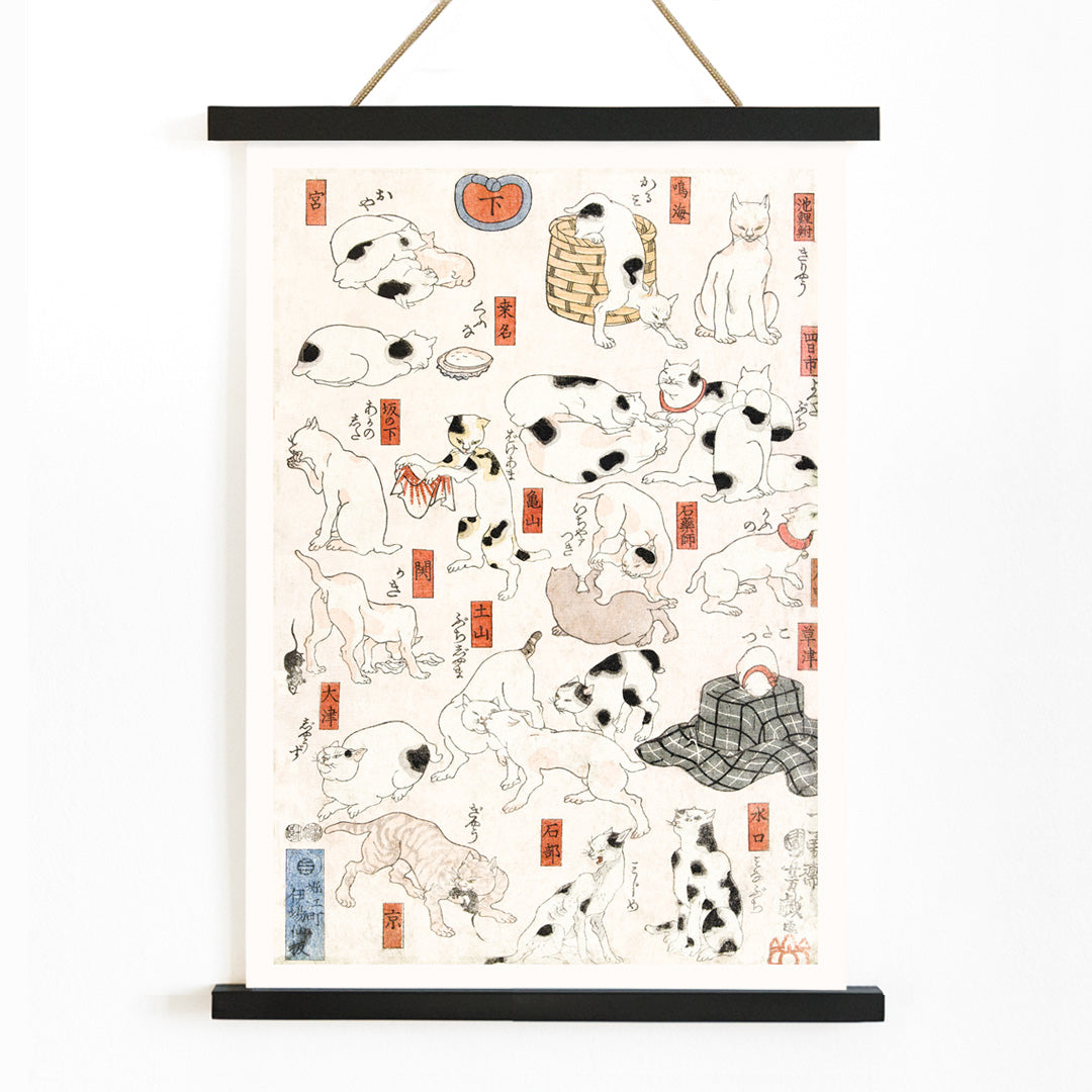 Playful and resting cats in traditional Japanese ukiyo-e art by Utagawa Kuniyoshi featuring multiple cats in various poses with Japanese elements, with wooden magnetic frame on white background