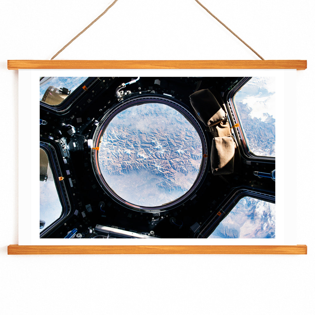 Earth view from International Space Station cupola by NASA with planet visible below poster artwork, with wooden magnetic frame on white background