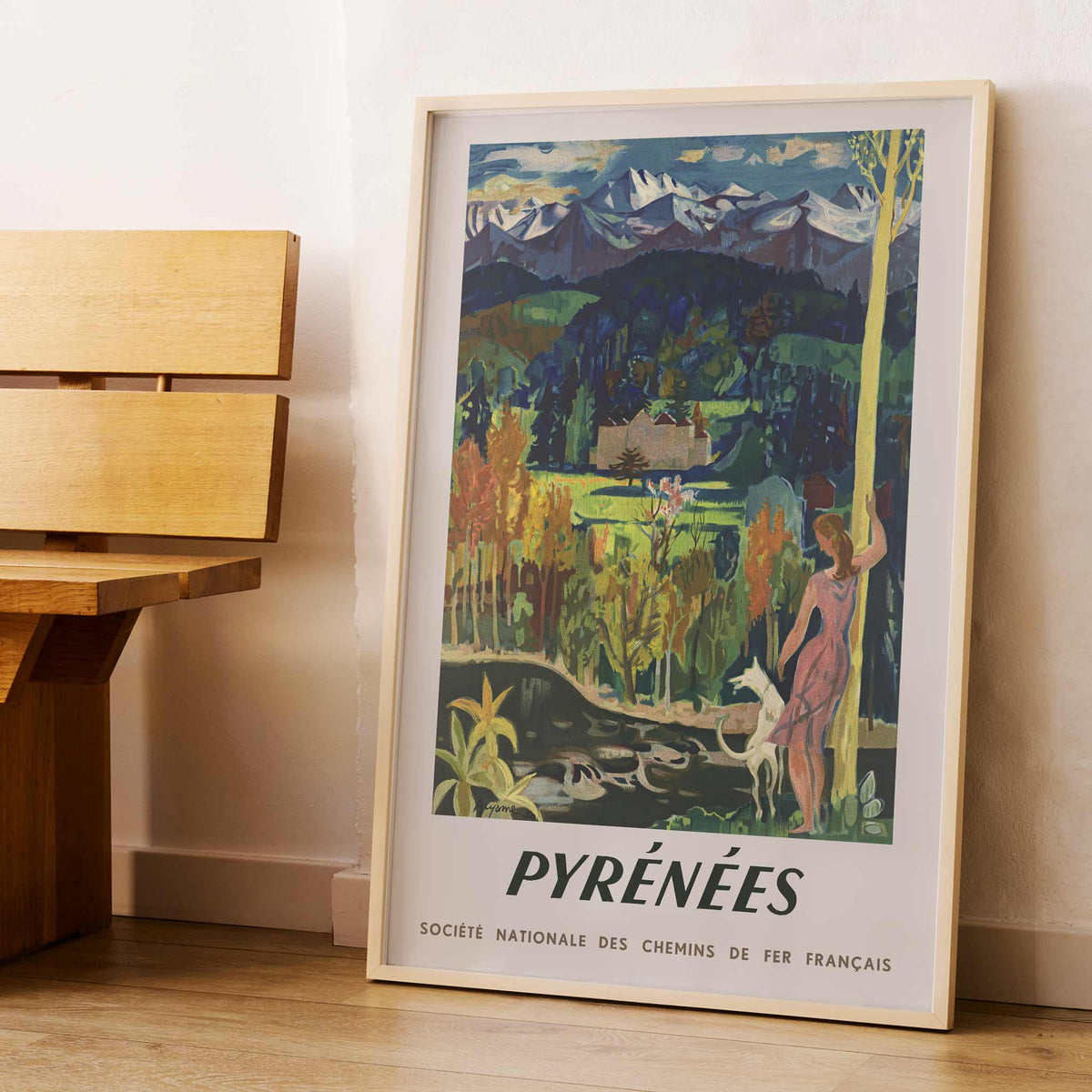 Pyrenees Railway poster by Roger Aujame with alpine peaks, green valley, blue skies, and woman by stream, with wooden magnetic frame on white background