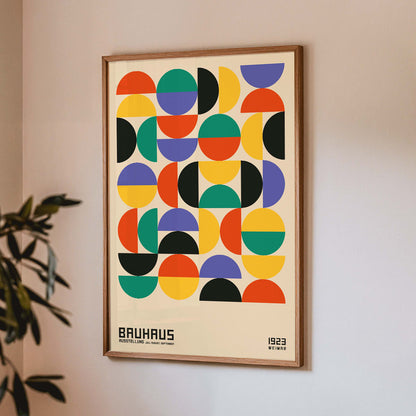 Bauhaus Poster 11 with colorful geometric shapes in a grid pattern inspired by the Weimar Exhibition artwork, framed and displayed in home decor