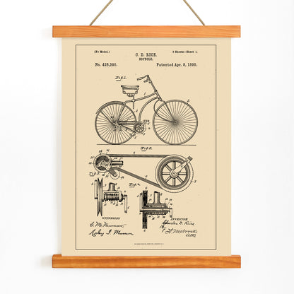 Bicycle technical illustration and mechanical parts drawing by C D Rice from Bicycle patent displayed on vintage background, with wooden magnetic frame on white background