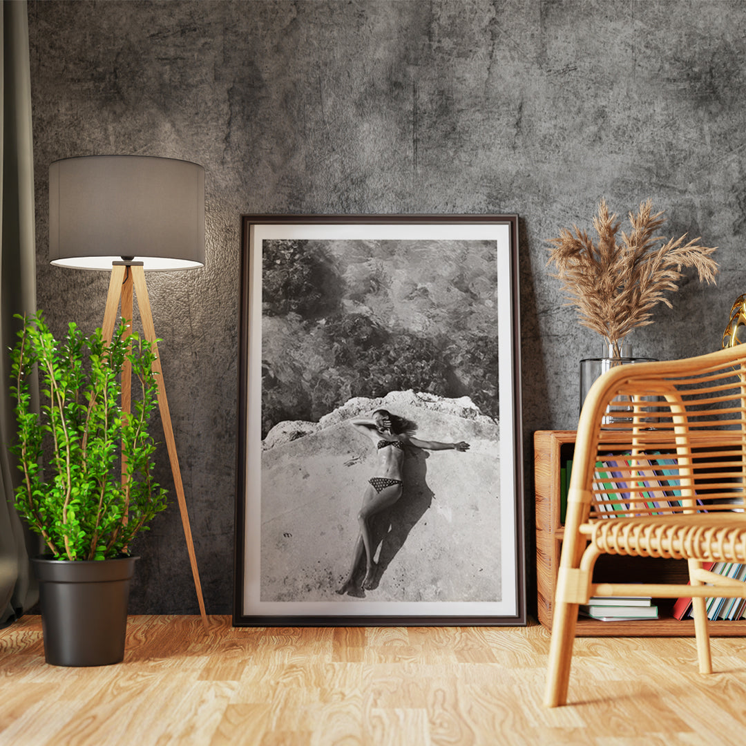 Woman in bikini lying on platform near water in Montego Bay Jamaica artwork by Nickerson Paine poster, framed and displayed in home decor