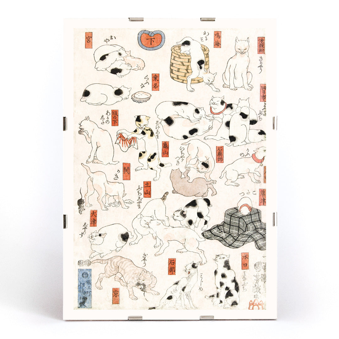 Playful and resting cats in traditional Japanese ukiyo-e art by Utagawa Kuniyoshi featuring multiple cats in various poses with Japanese elements, framed and displayed in modern living room decor