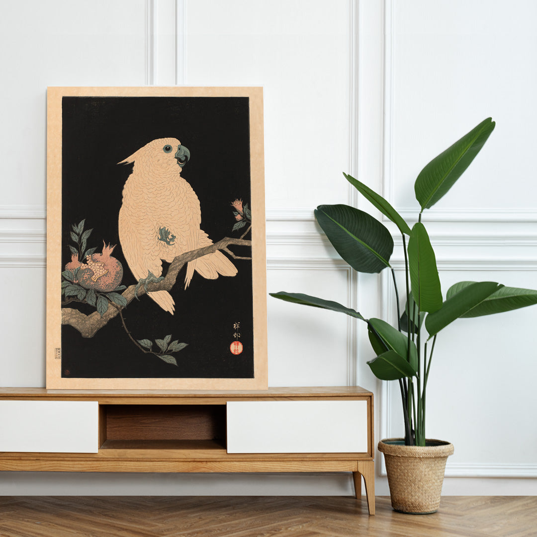 White cockatoo perched on a branch with pomegranate artwork by Ohara Koson poster, framed and displayed in home decor