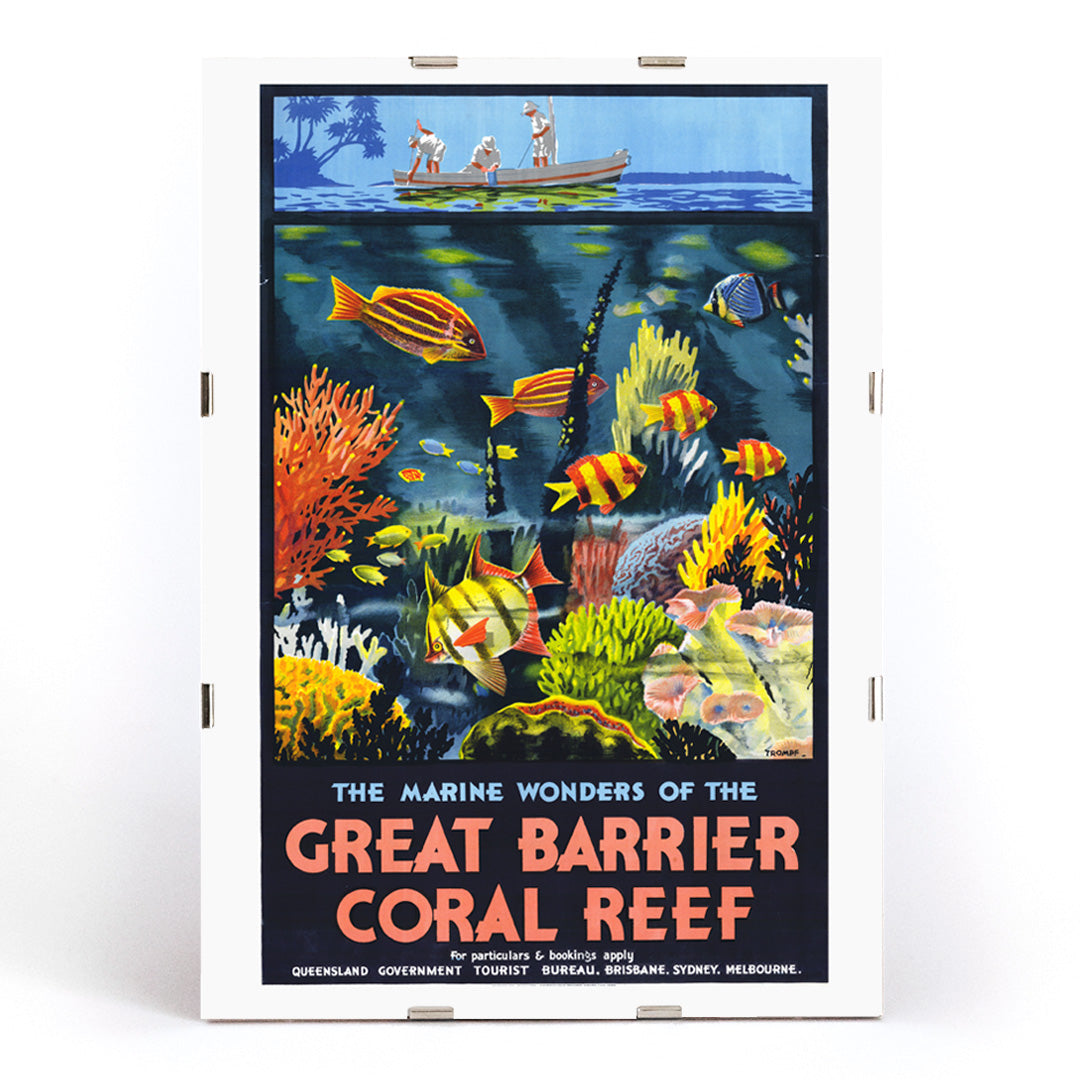 Colorful coral reef and tropical fish with people in a boat above artwork The Marine Wonders of the Great Barrier Coral Reef by Percival Albert Trompf, framed and displayed in modern living room decor