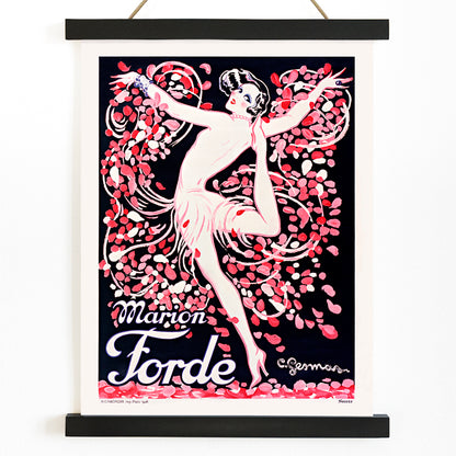 Art Deco poster of Marion Forde by Charles Gesmar featuring a dancer in a pink dress surrounded by vibrant swirling petals, with wooden magnetic frame on white background