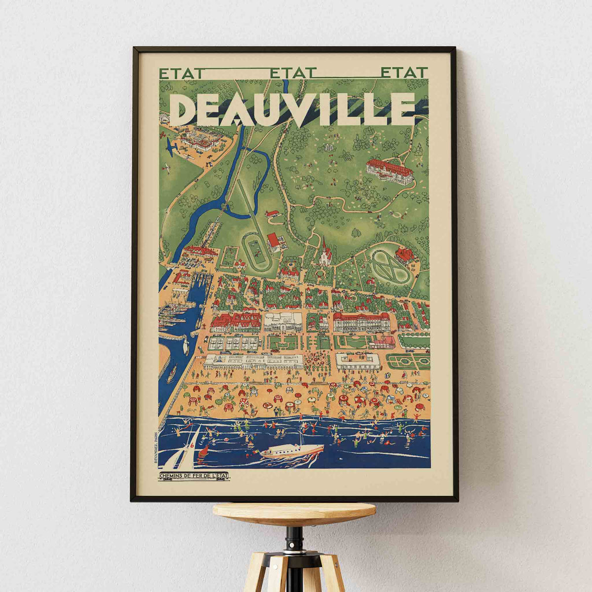 Deauville railway travel poster vintage coastal resort map with beaches boats waterways and countryside, framed and displayed in modern living room decor