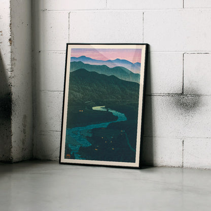 Ecchu Umidani Pass by Kawase Hasui landscape artwork showing mountains and a winding river at dawn and dusk, framed and displayed in home decor