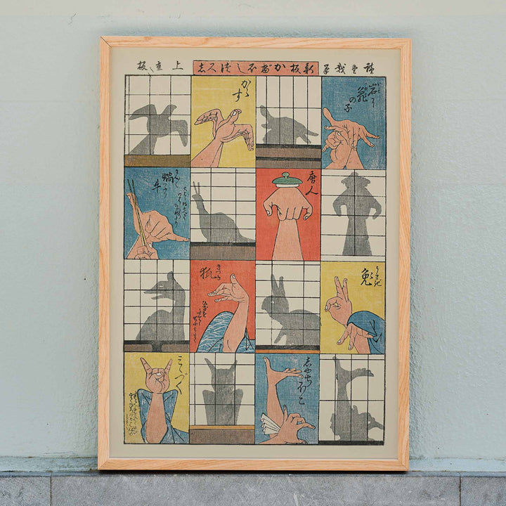 Utagawa Hiroshige Eight Shadow Figures poster with colorful hand gestures and ukiyo-e style panels, framed and displayed in home decor