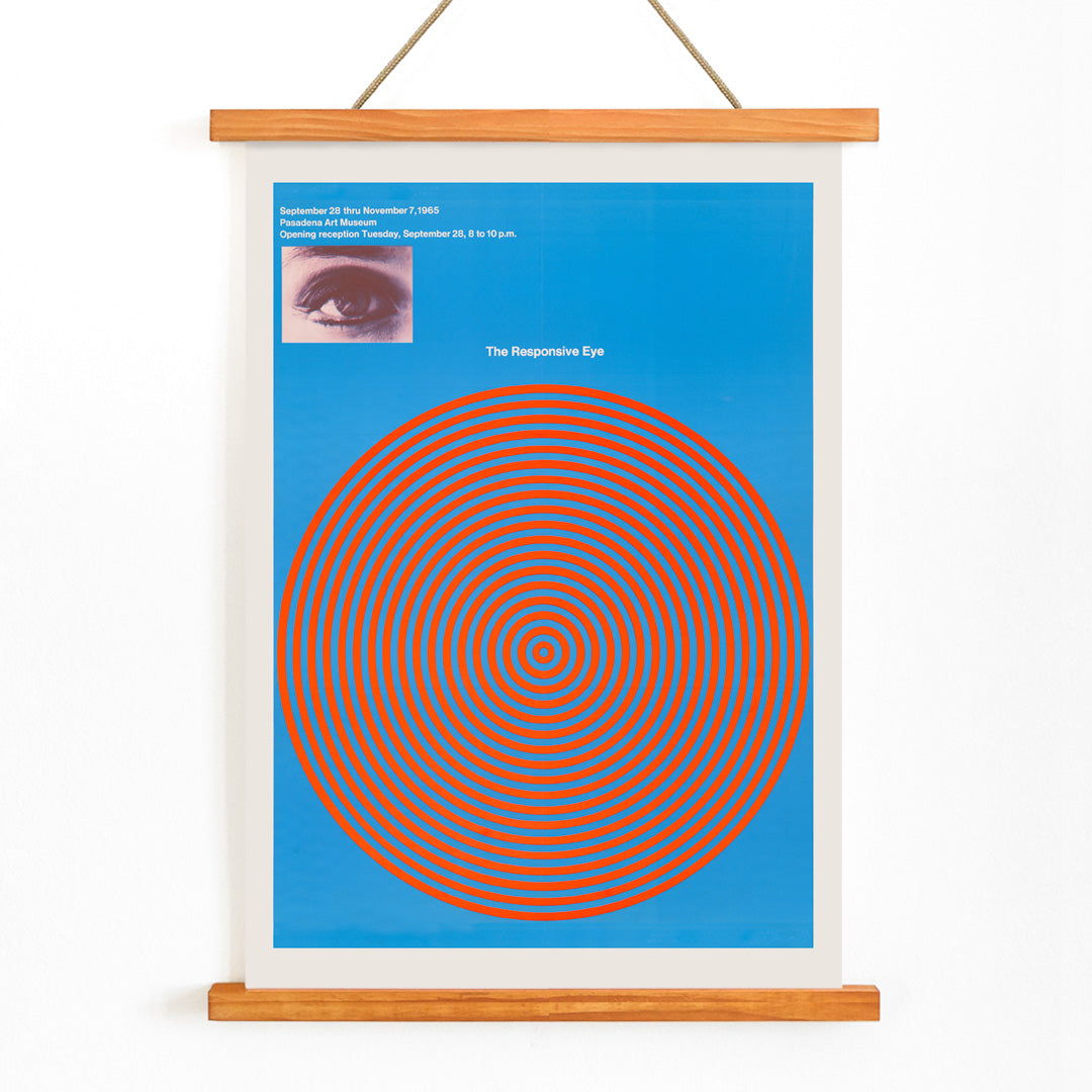 Op art poster with blue and red concentric circles and eye detail from The Responsive Eye by Patrick Blackwell, with wooden magnetic frame on white background