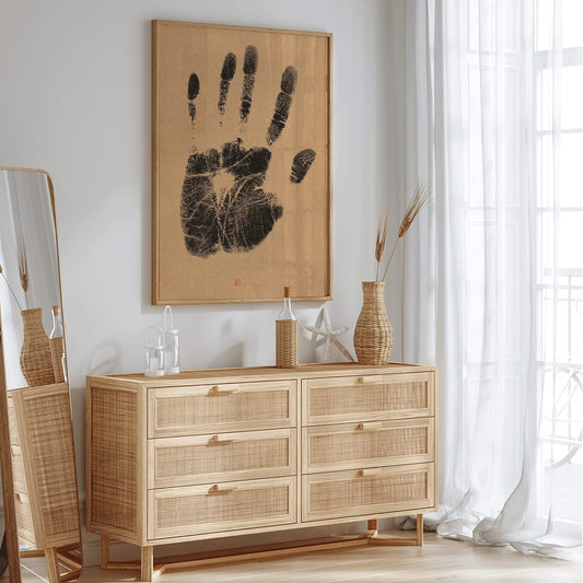Black ink handprint artwork titled The Artists Left Hand by Henri Charles Guerard on beige background, framed and displayed in home decor