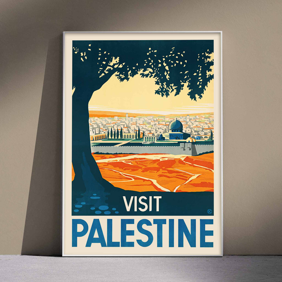 Franz Kraus Visit Palestine poster with sunlit city, mosque, ochre fields, blue sky, and dark tree silhouette, framed and displayed in modern living room decor