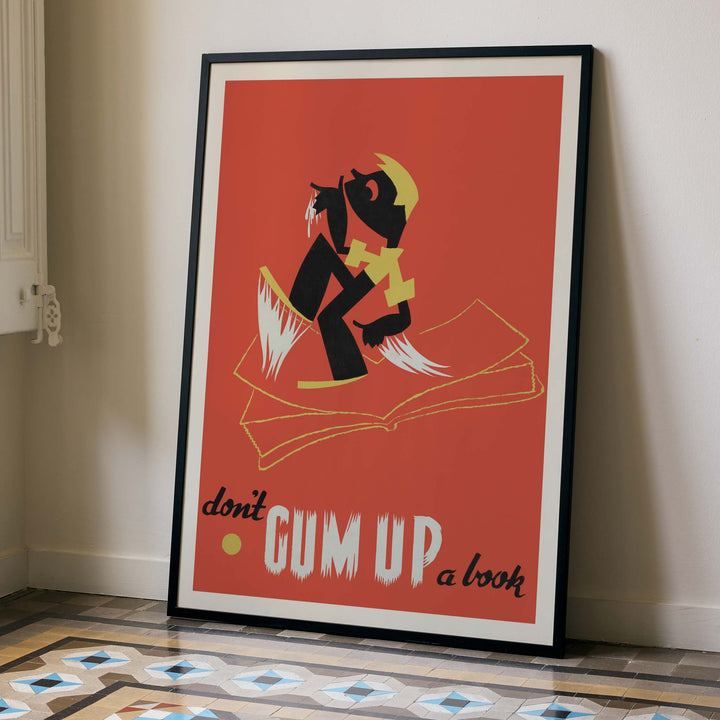 Arlington Gregg Dont gum up a book poster with bold black figure over open book on red background with yellow accents, with wooden magnetic frame on white background