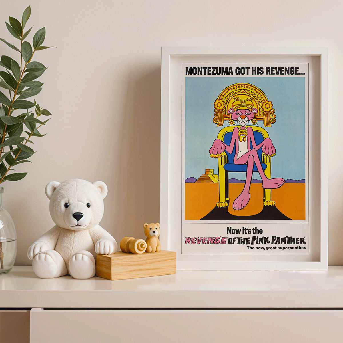 Pink Panther Montezuma themed artwork and poster titled Revenge of the Pink Panther featuring the Pink Panther sitting on a throne, framed and displayed in modern living room decor