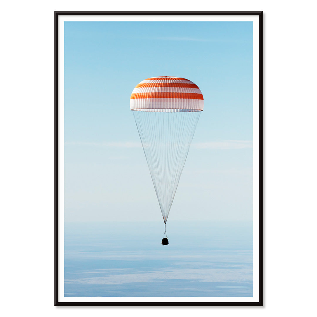 Soyuz MS-02 spacecraft descending with parachute over Kazakhstan NASA poster titled The Soyuz MS-02 spacecraft lands, with black aluminium frame on white background