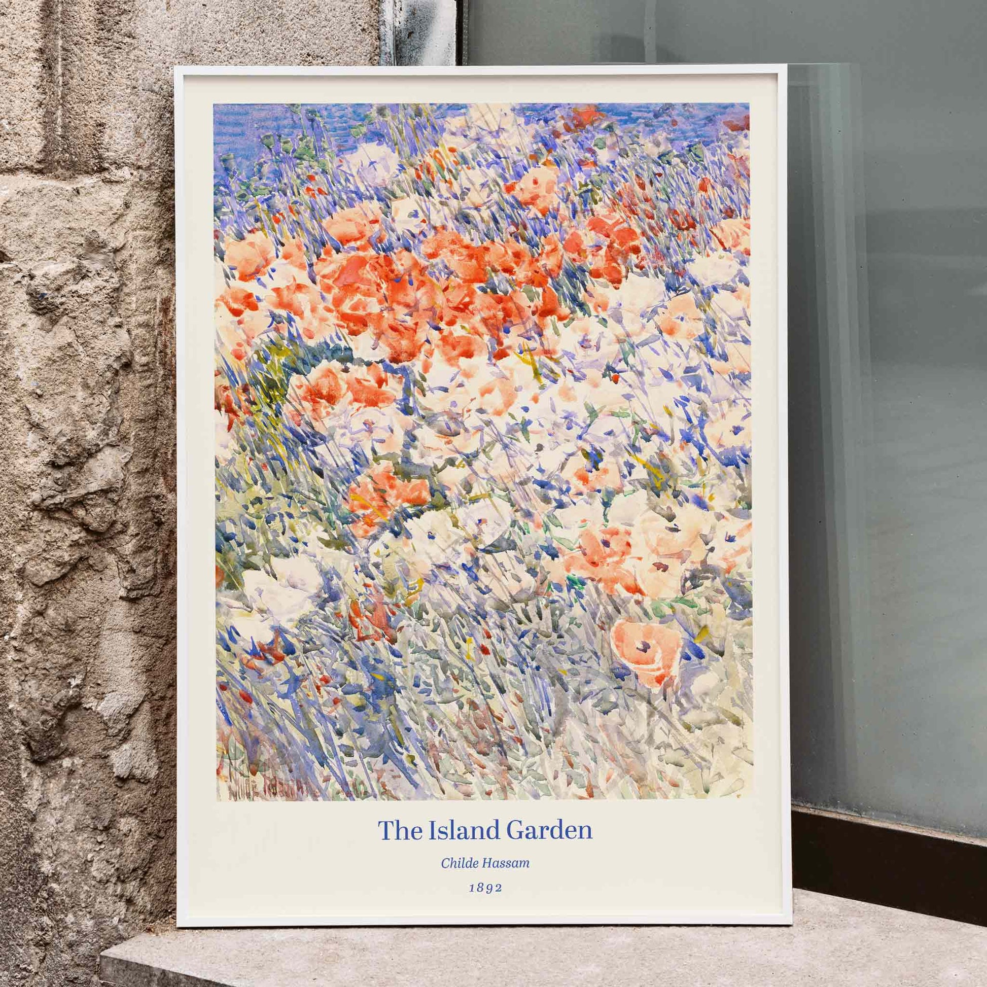 Colorful floral painting The Island Garden by Childe Hassam featuring vibrant wildflowers and a lush garden scene, framed and displayed in home decor