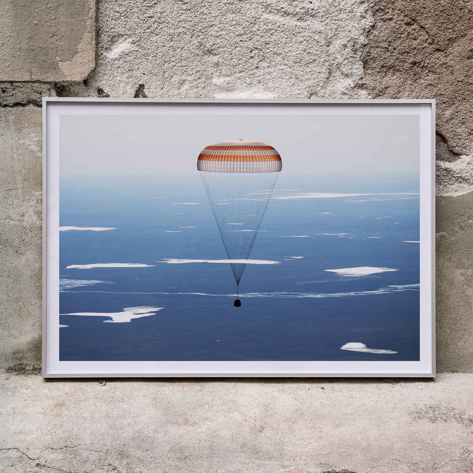 Soyuz MS-02 spacecraft descending with parachute over Kazakhstan NASA poster artwork showing landing, framed and displayed in home decor