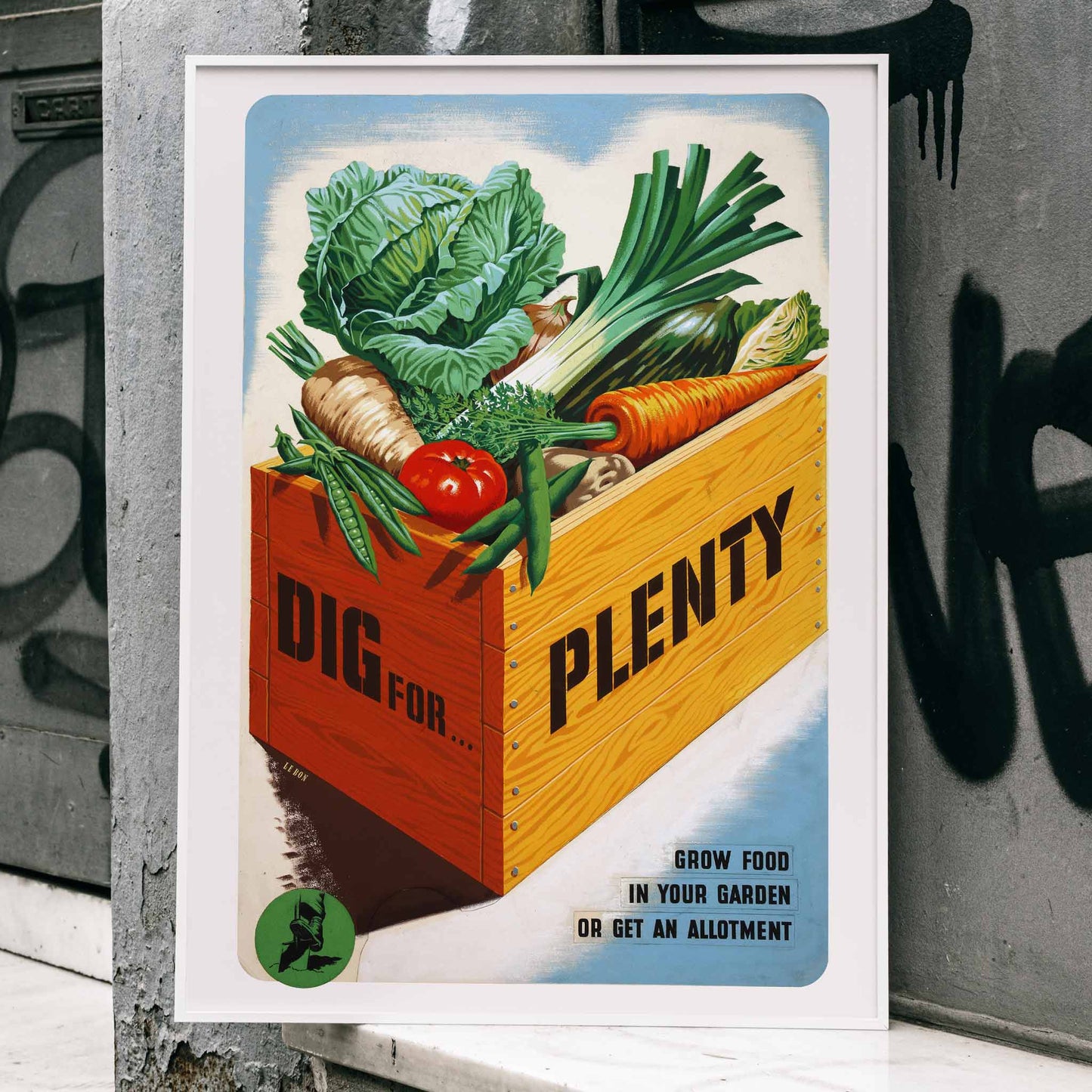 Vintage poster of a crate of fresh garden vegetables with text Dig for Plenty promoting self-sufficiency artwork by Mary Le Bon, framed and displayed in home decor