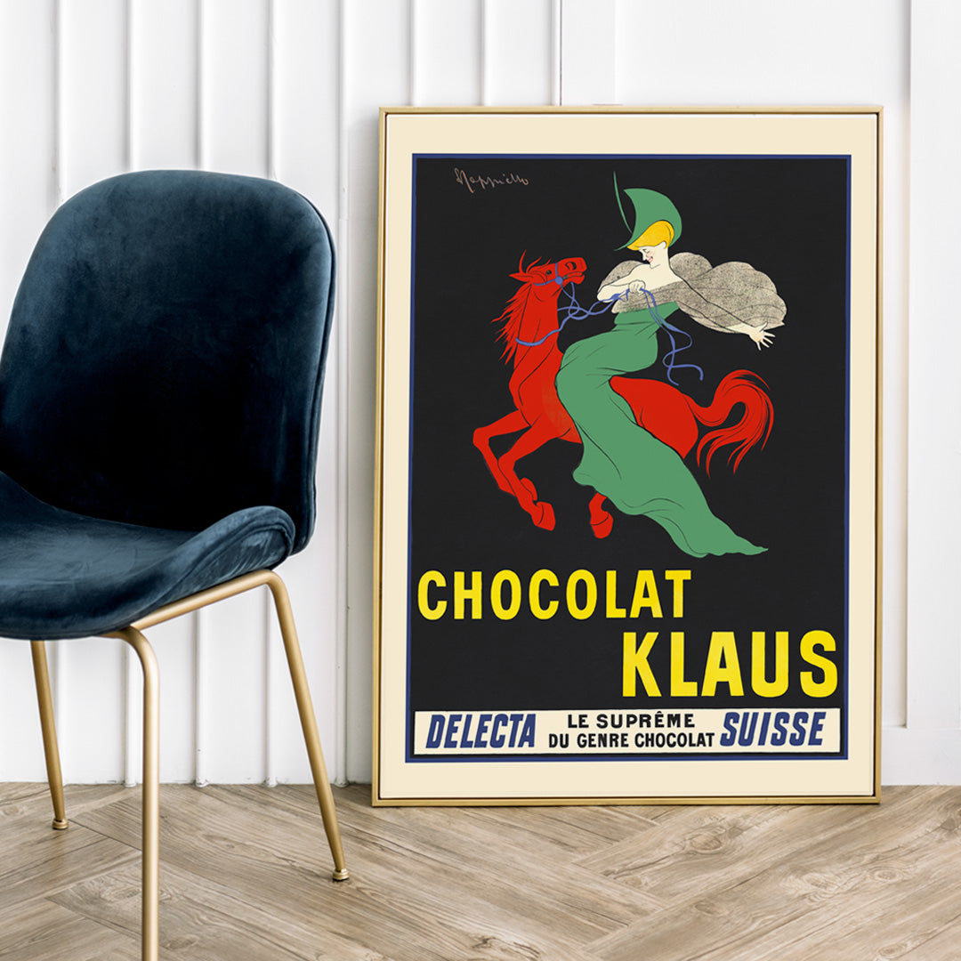 Chocolat Klaus poster by Leonetto Cappiello showing a woman in a flowing green dress riding a red horse on a black background, framed and displayed in home decor