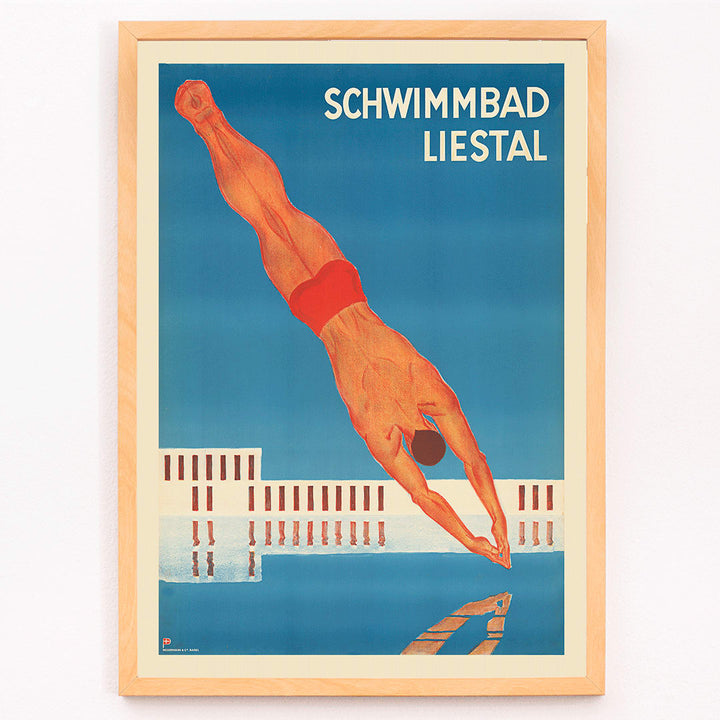 Schwimmbad Liestal poster by artist showing a man diving into a pool with a modern building in the background, framed and displayed in modern living room decor