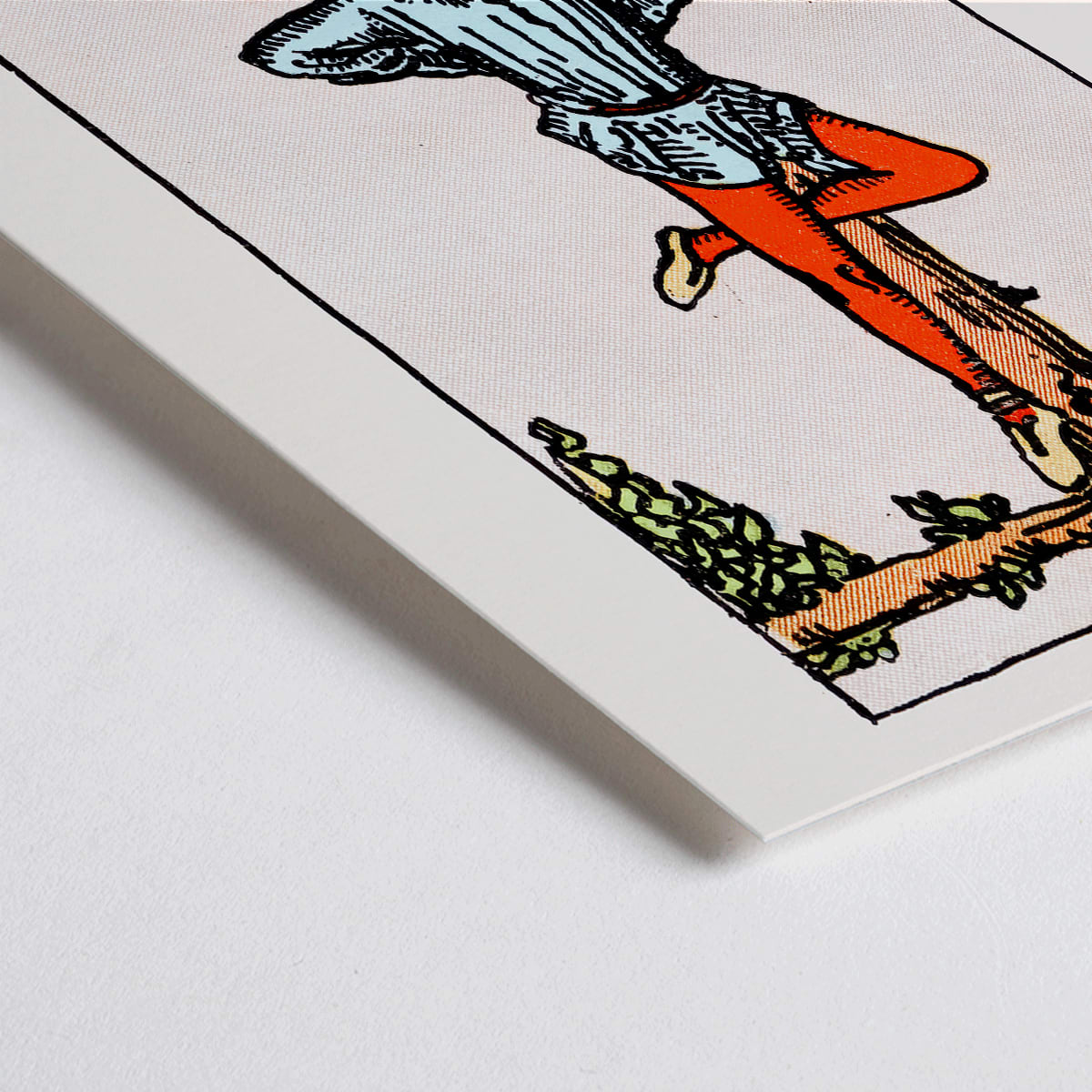 Closeup detail of Hanged Man Tarot Card by Rider Waite, figure hanging upside down from wooden structure, mystical poster art