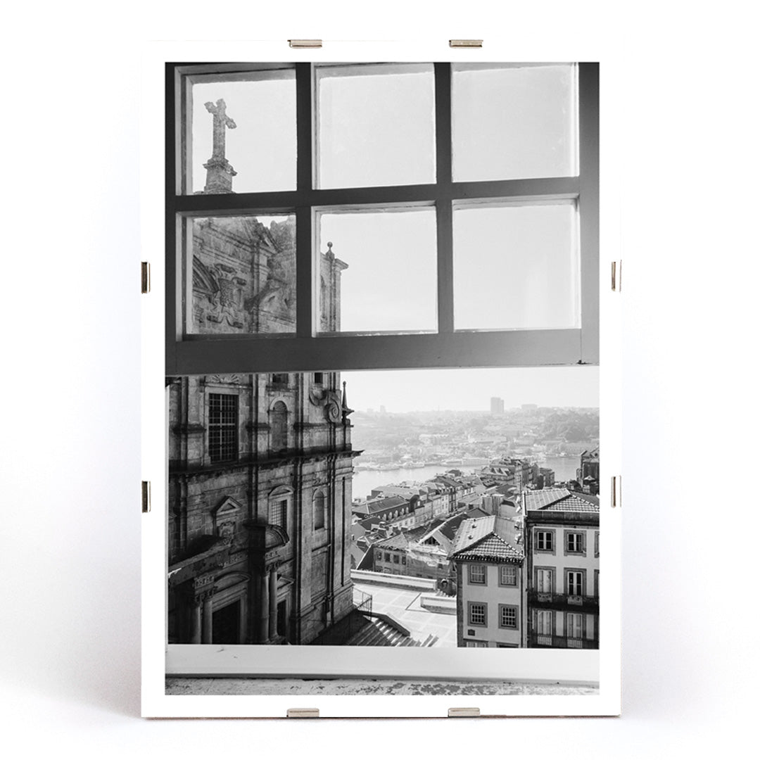 Black and white cityscape poster of Porto seen through a window from the artwork Porto from window, framed and displayed in modern living room decor