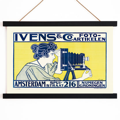 Art nouveau poster of woman using vintage camera at Ivens and Co Camera Shop by Johann Georg van Caspel, with wooden magnetic frame on white background
