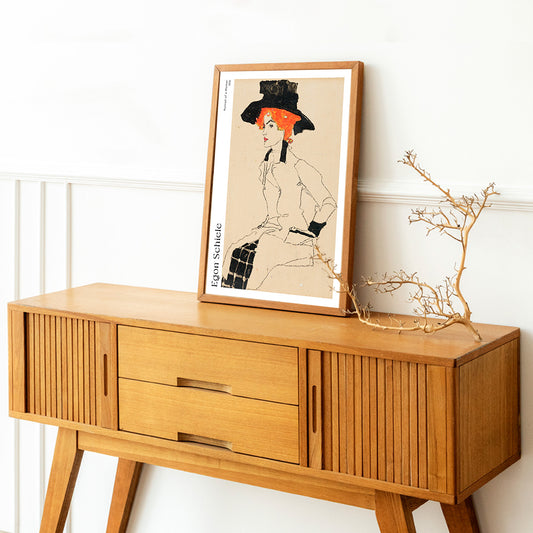 Portrait Of A Woman by Egon Schiele featuring an elegant woman with red or orange hair and a black hat poster, framed and displayed in home decor