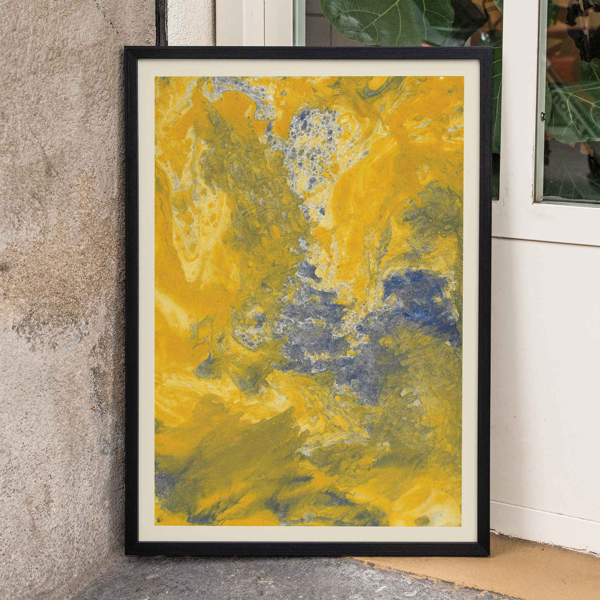 Margarete Rumpf Yellow marbled paper poster with swirling ochre, cream and blue-grey abstract textures, framed and displayed in home decor